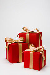 Red gift boxes decorated with gold ribbon.