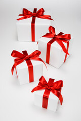 Gift boxes decorated with red ribbons.