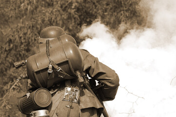  Person in German WW2 military uniform with flame-thrower. Historical military reenacting in Kiev