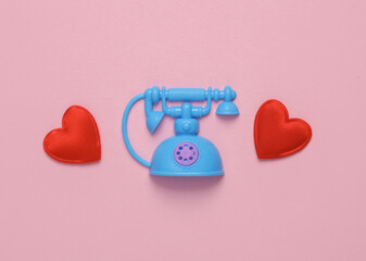 Toy Retro rotary phone with heart on pink background. Romantic, love, valentine's day concept