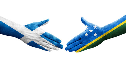 Handshake between Solomon Islands and Scotland flags painted on hands, isolated transparent image.