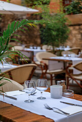 A table at an outdoor restaurant with traditional old terracotta houses in old town or Vieille Ville in Villefranche sur Mer, South of France