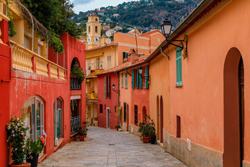 Traditional old terracotta houses on a narrow street in the Old Town of Villefranche sur Mer on the...