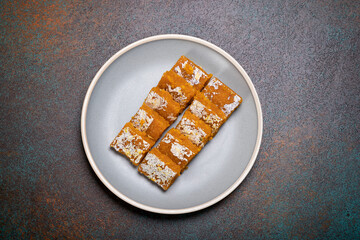 Traditional Indian delicacy moong dal burfi prepared with moong dal or yellow lentils with dry fruits