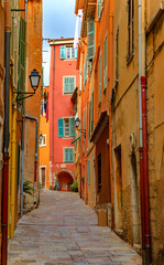 Obraz na płótnie Canvas Traditional old terracotta houses on a narrow street in the Old Town of Villefranche sur Mer on the French Riviera, South of France