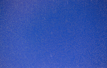 Blue background of decorative plaster with abstract spots. Unusual texture of this wall with beautiful patterns, creative surface background. Finishing coating for building cladding.