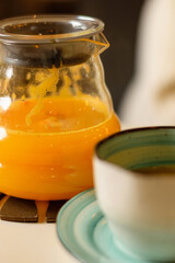 Sea buckthorn tea in a glass teapot in a cafe,close-up,selective focus.Healthy eating and healthy lifestyle.Vegetarian and vegan diet.Veganuary concept.
