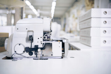 Professional overlock at sewing production in workshop