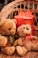 Teddy bears in wooden sleds. Red box with Christmas gift