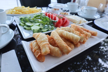 Traditional Turkish Breakfast with cheese rolls and some vegetables