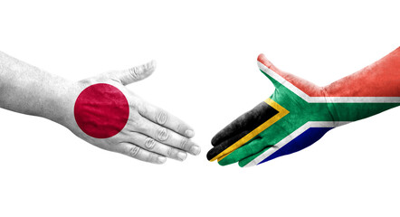 Handshake between South Africa and Japan flags painted on hands, isolated transparent image.