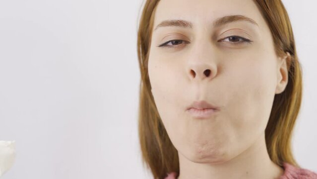 Close-up portrait of woman eating Turkish delight.
Close-up of woman eating Turkish delight.
