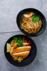 Lunch chicken with rice and chicken noodle broth and egg in bowls