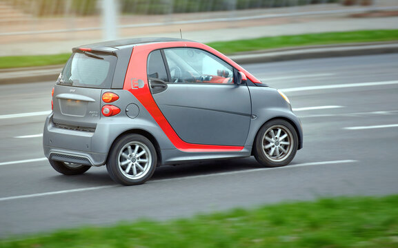Minsk, Belarus. Nov 2022. Smart Electric Drive car riding fast, side view. Speed driving on asphalt road at city street