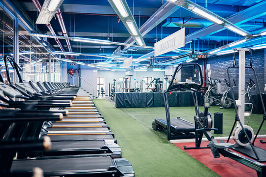 Empty gym, equipment and studio for fitness, exercise and sports or wellness training indoors. Treadmill, machines and health center for workout, athletics and motivation for race or marathon