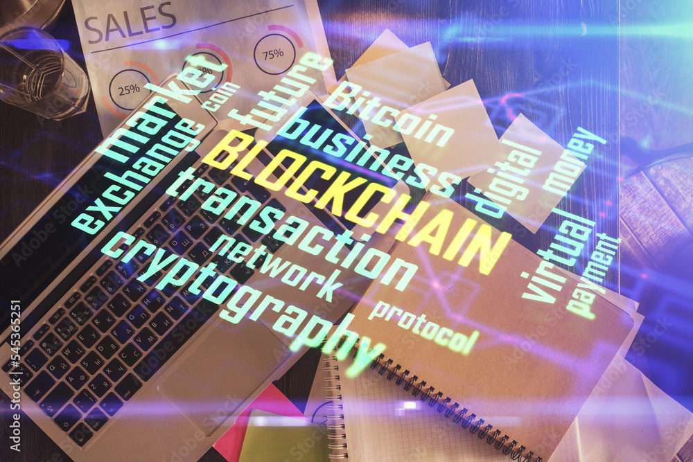 Poster Blockchain theme hologram drawings over computer on the desktop background. Top view. Double exposure.