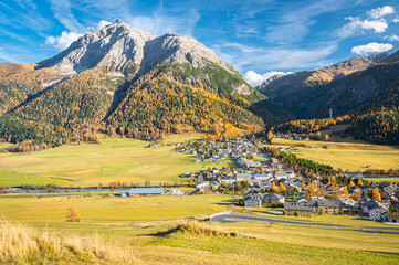 Fototapeta na wymiar Scenic view of the village of La Punt Chamues-ch in Engadin valley, Switzerland on a sunny day in autumn