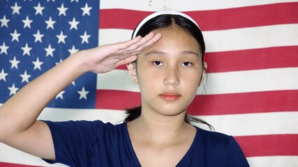Fototapeta premium Patriotic Asian Female Saluting With Usa Flag