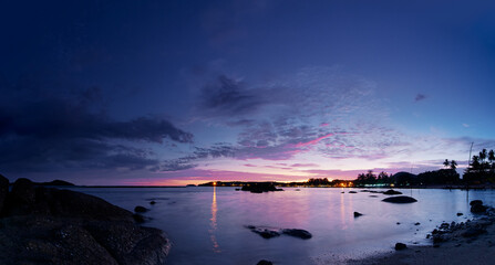 Fototapeta na wymiar Beautiful seascape with colorful sky. Sunset and night time on the rock beach.