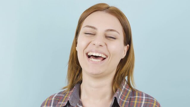 Close-up of laughing woman.
Young woman laughing happy and having fun.

