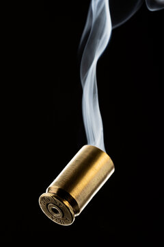 Cartridge cases with smoke falling on black background Stock Photo ...