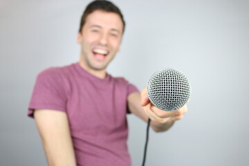 Happy Caucasian Man showing Microphone 