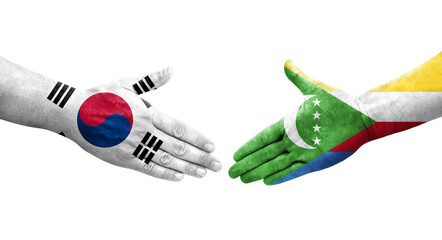 Handshake between South Korea and Comoros flags painted on hands, isolated transparent image.