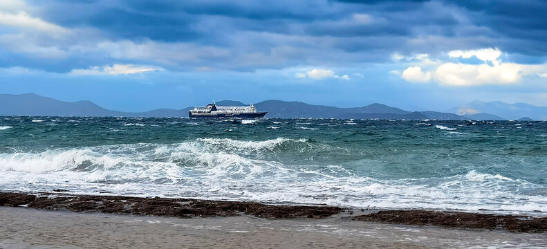 Ferry is leaving the Rafina's port under a dramatic sky and bad whether