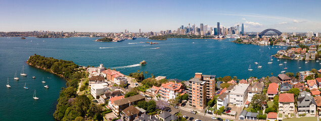 Fototapeta premium Panoramic aerial drone view of Sydney Harbour looking from Cremorne Point on the Lower North Shore of Sydney, NSW, Australia, with Sydney City in the background on a sunny day 