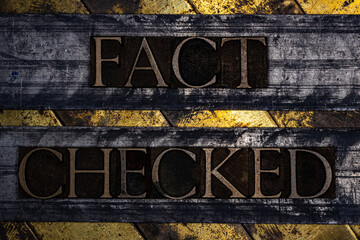 Fact Checked text with on grunge textured copper and gold background 