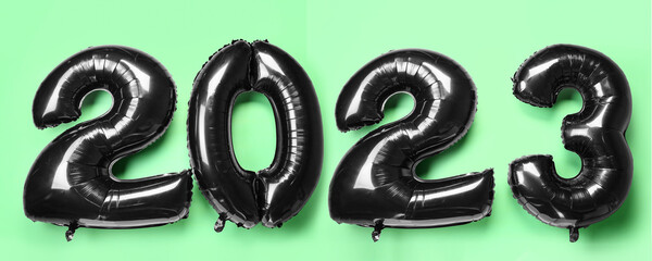 Figure 2023 made of balloons on green background