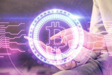 Double exposure of man's hands holding and using a phone and crypto currency blockchain theme drawing.