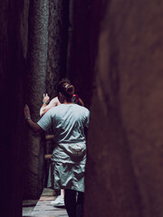 people on the mountain path between the rocks