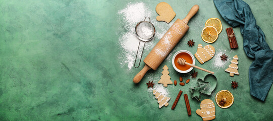Composition with tasty Christmas cookies, ingredients and kitchenware on green background with space for text