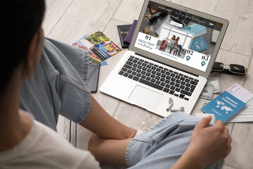 Female travel blogger with laptop, earphones and immune passport on light wooden floor