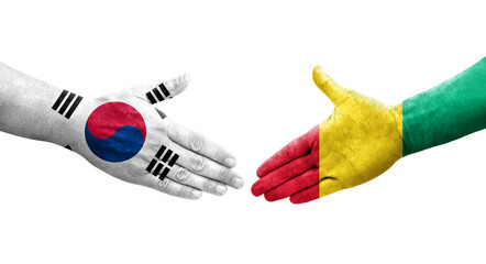 Handshake between South Korea and Guinea flags painted on hands, isolated transparent image.