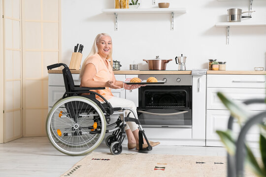 Mature Woman With Physical Disability Baking Pastry In Kitchen