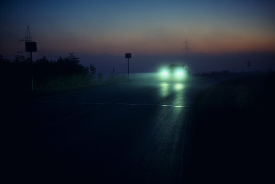 car on the night road, car headlights, foggy road