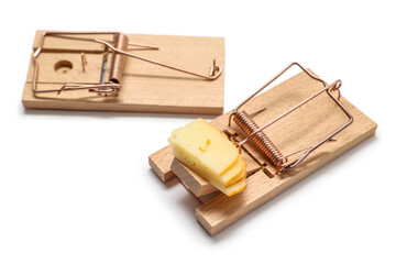 Wooden mousetraps with cheese on white background