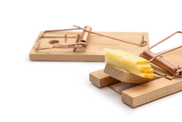 Wooden mousetraps with cheese on white background