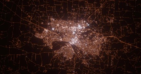 Salem (Oregon, USA) aerial view at night. Top view on modern city with street lights. Camera is zooming out, rotating clockwise. Vertical video. The north is on the left side