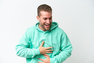 Young handsome caucasian man isolated on white background smiling a lot