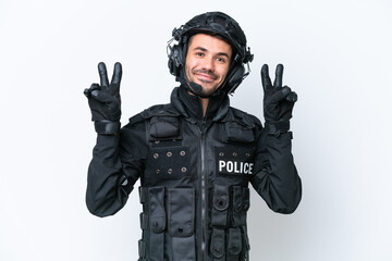 Young caucasian SWAT man isolated on white background showing victory sign with both hands