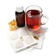 Mustard plasters with cough syrup, pills and cup of tea on white background