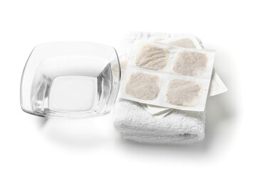 Mustard plasters with towel and bowl of water on white background