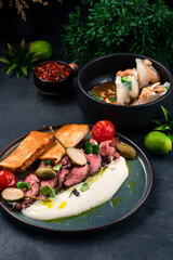 Italian food Vitello tonnato, sliced tuna, capers, tomatoes, sauce, fried toast with spring rolls with shrimps, cucumbers, rice and cashew nuts with sauce.
