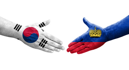Handshake between South Korea and Liechtenstein flags painted on hands, isolated transparent image.