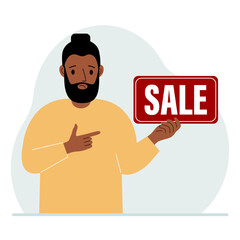 A man holds a banner with the text sale. Points a finger at the text. The concept of a discount, a special offer in a store or a bank, an advertising flyer.