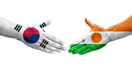 Handshake between South Korea and Niger flags painted on hands, isolated transparent image.