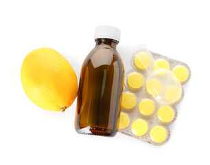 Pills for sore throat, cough syrup, spoon and lemon on white background